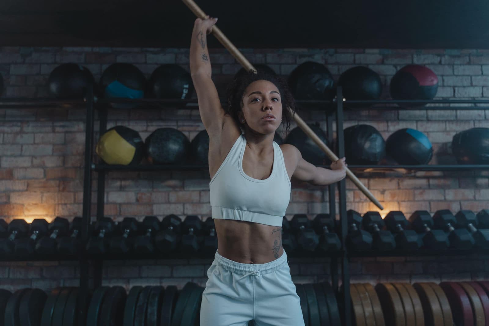 Dani demonstrating an overhead position with a dowel