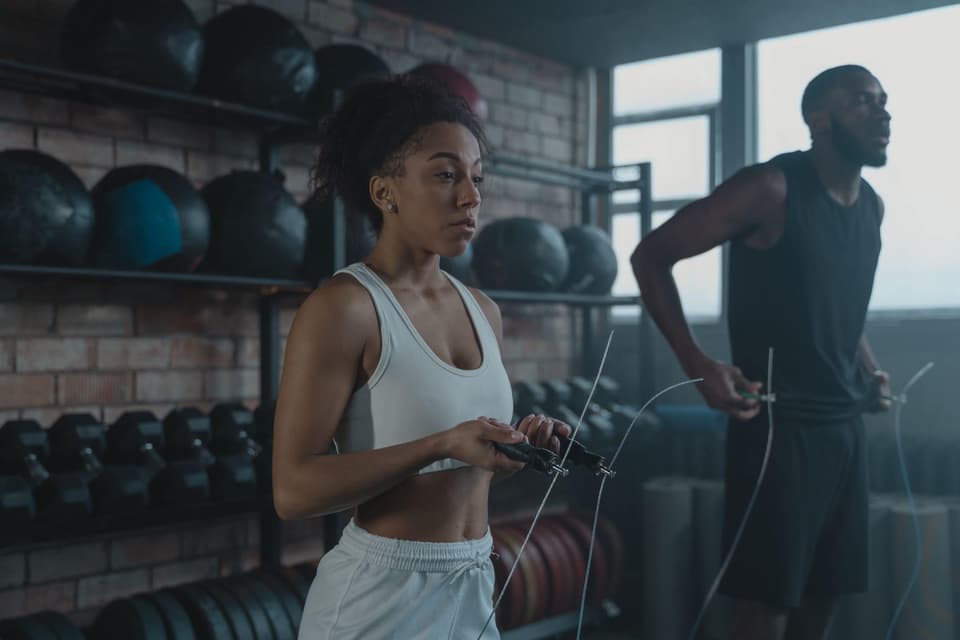 Dani training with a jump rope beside a client