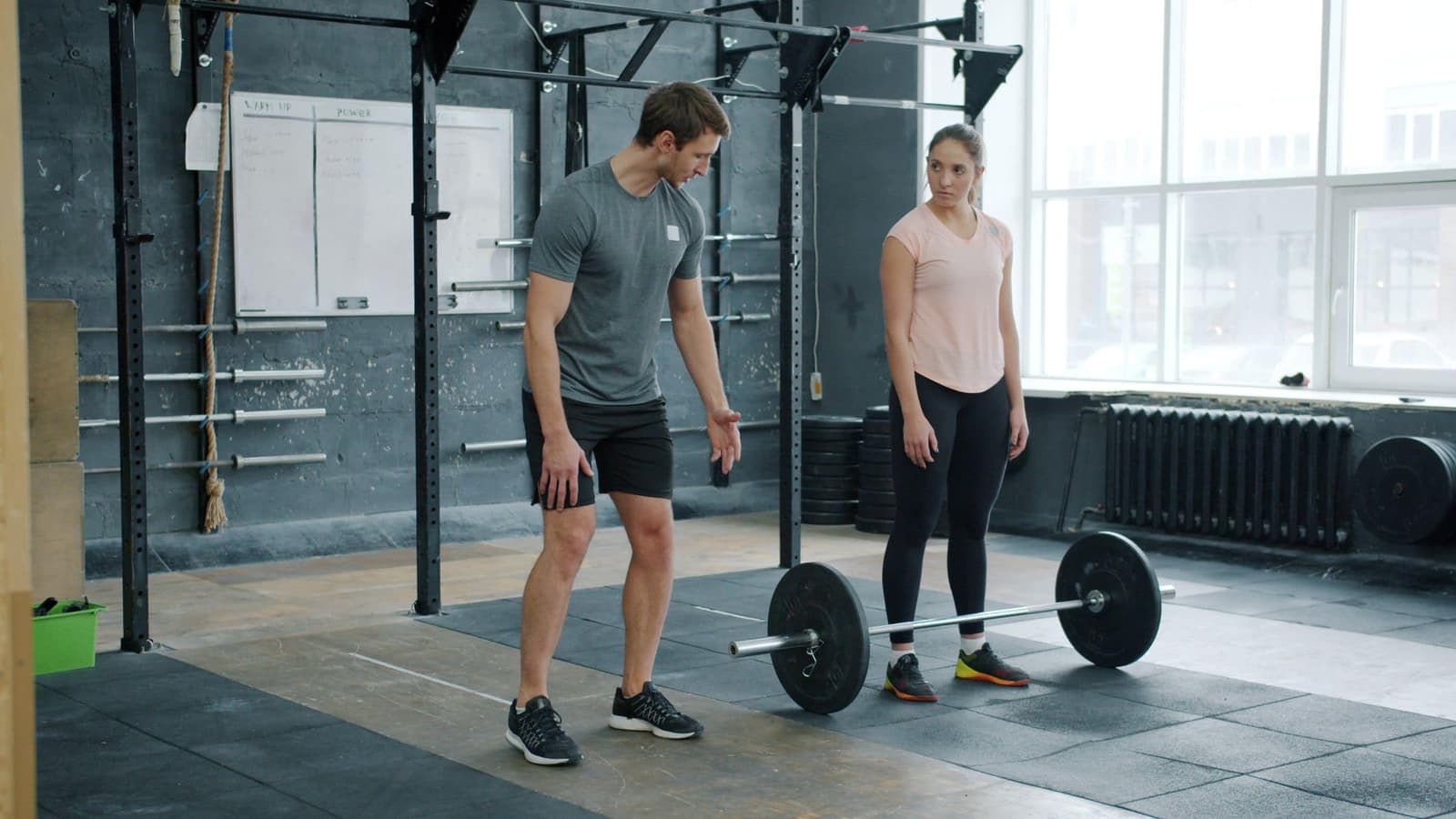 Theo coaching a client through a barbell setup