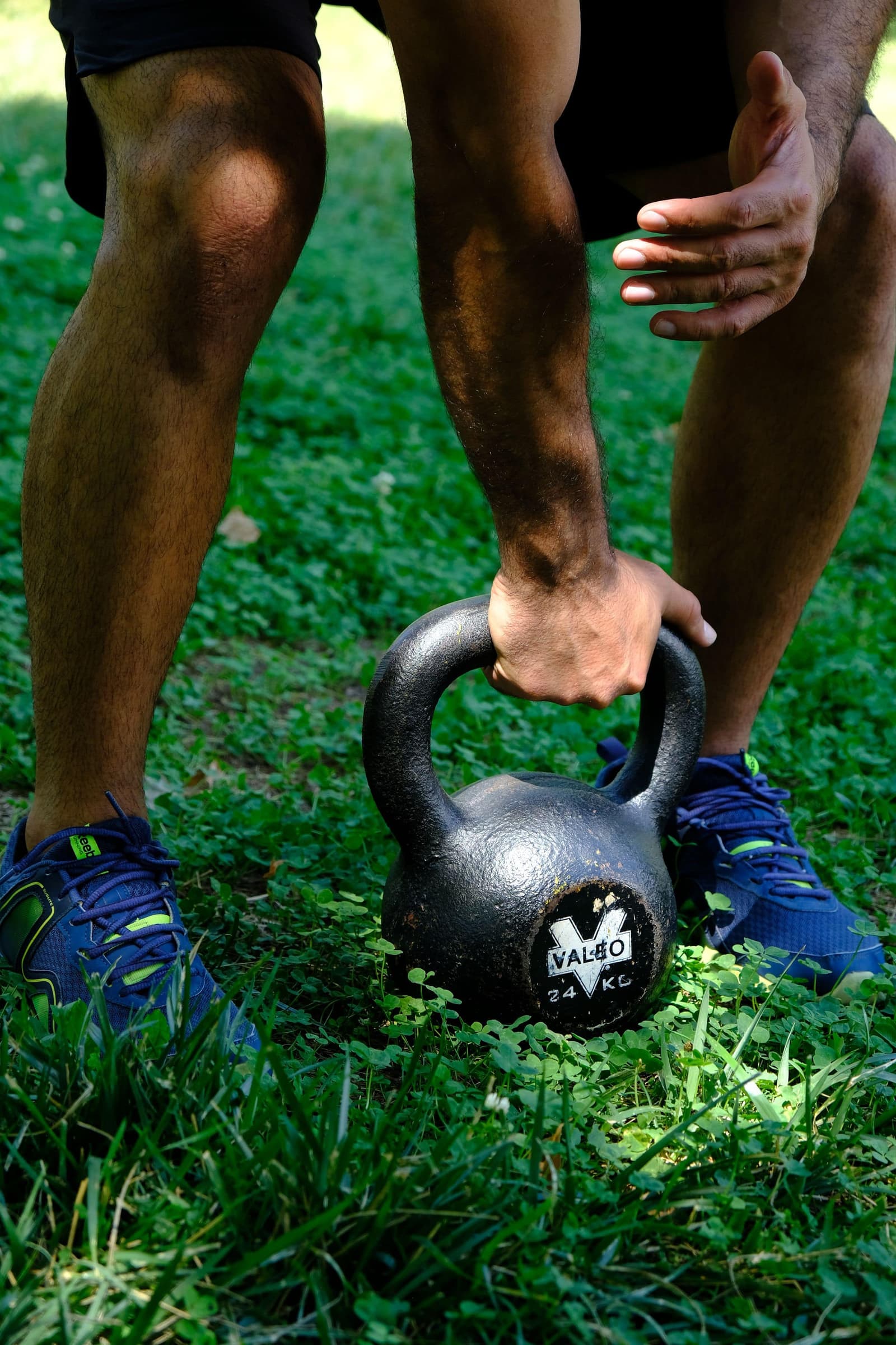 A kettlebell lifted off the grass in morning light